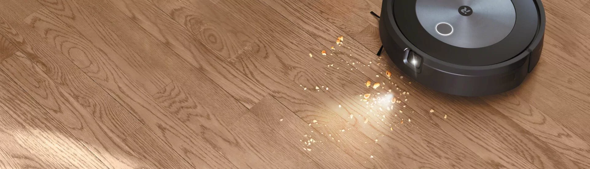 iRobot Roomba uklízející drobky na podlaze